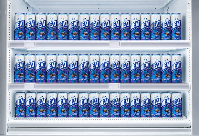 Straight-on shot of an empty white refrigerated retail shelf with price-tag rails, cold light