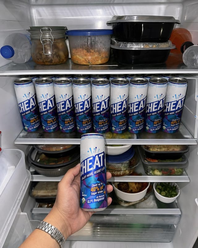 An open home refrigerator fully stocked, refrigerator light, shelves packed with drinks and takeaway containers, phone photo with flash